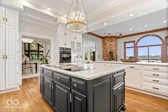11715 Landings Dr, Indianapolis, IN 46256 - kitchen with white cabinetry, black appliances, ornamental molding, healthy amount of natural light, and recessed lighting