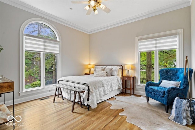 11715 Landings Dr, Indianapolis, IN 46256 - bedroom with multiple windows, crown molding, wood finished floors, a ceiling fan, and baseboards