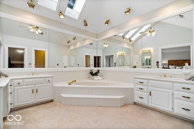 11715 Landings Dr, Indianapolis, IN 46256 - full bathroom featuring a skylight, lofted ceiling, a ceiling fan, and two vanities