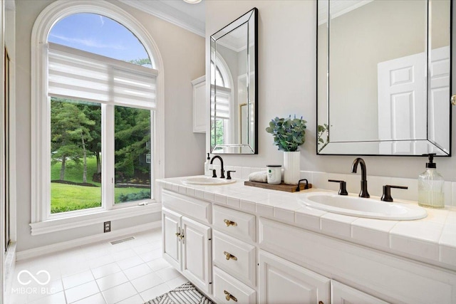 11715 Landings Dr, Indianapolis, IN 46256 - full bath featuring double vanity, ornamental molding, tile patterned flooring, and baseboards
