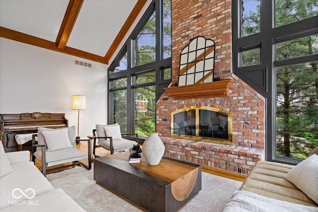 11715 Landings Dr, Indianapolis, IN 46256 - living area featuring high vaulted ceiling, beam ceiling, wood finished floors, and a brick fireplace