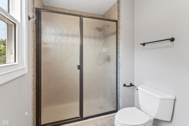 11226 Blackwalnut Pt, Indianapolis, IN 46236 - full bath with a shower stall, toilet, tile patterned floors, and a textured ceiling