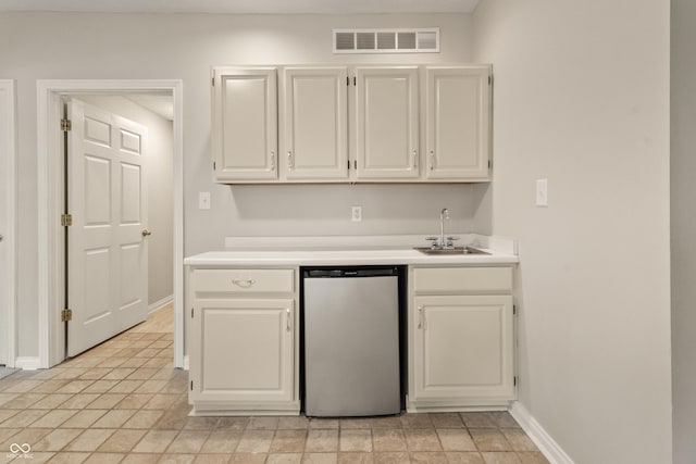 11226 Blackwalnut Pt, Indianapolis, IN 46236 - kitchen featuring a sink, dishwasher, light countertops, and baseboards