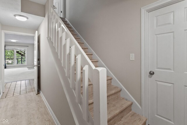 11226 Blackwalnut Pt, Indianapolis, IN 46236 - stairway featuring wood finished floors and baseboards