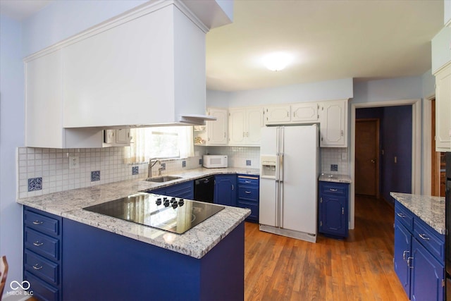7401 Spring Mill Rd, Indianapolis, IN 46260 - kitchen with black appliances, blue cabinetry, a sink, decorative backsplash, and dark wood finished floors