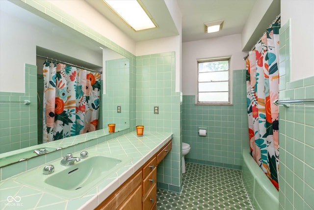 7401 Spring Mill Rd, Indianapolis, IN 46260 - bathroom with tile walls, a wainscoted wall, toilet, tile patterned floors, and vanity