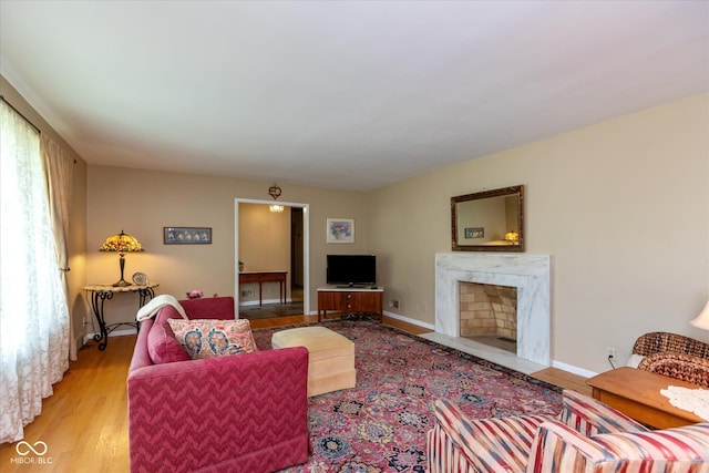 7401 Spring Mill Rd, Indianapolis, IN 46260 - living area featuring light wood finished floors, a high end fireplace, and baseboards