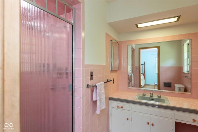 7401 Spring Mill Rd, Indianapolis, IN 46260 - bathroom featuring tile walls, vanity, and an enclosed shower