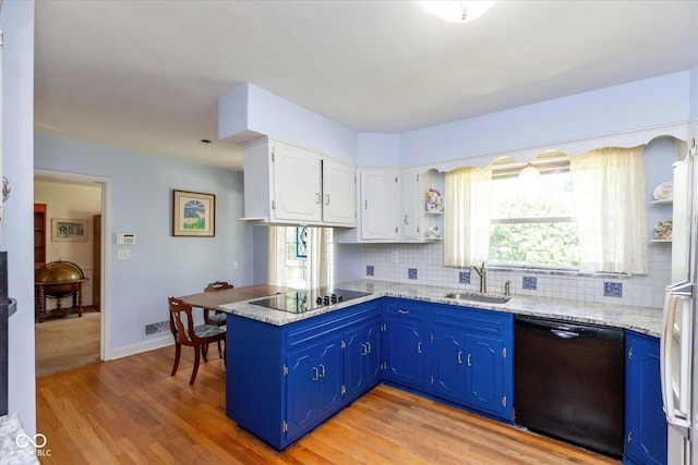 7401 Spring Mill Rd, Indianapolis, IN 46260 - kitchen featuring black appliances, a sink, a peninsula, backsplash, and light wood-style floors