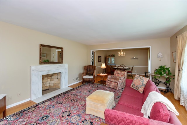 7401 Spring Mill Rd, Indianapolis, IN 46260 - living area with a chandelier, wood finished floors, a high end fireplace, and baseboards