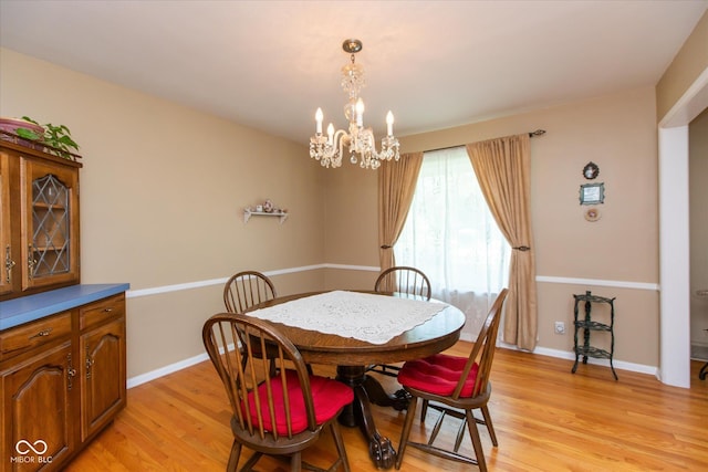 7401 Spring Mill Rd, Indianapolis, IN 46260 - dining area featuring a chandelier, light wood-type flooring, and baseboards