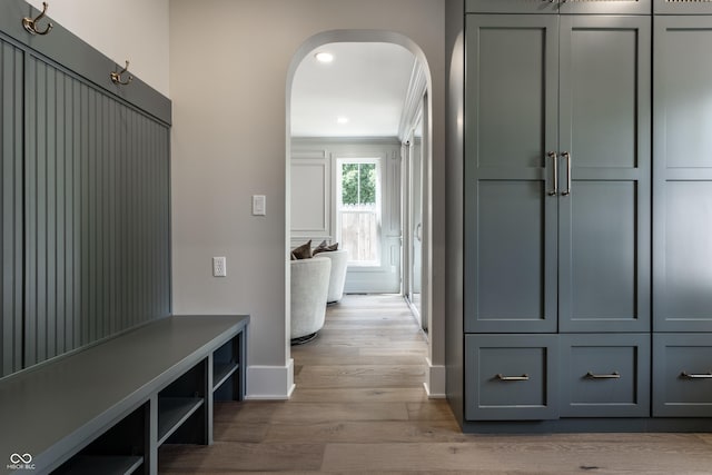 5682 Broadway St, Indianapolis, IN 46220 - mudroom featuring arched walkways, baseboards, wood finished floors, crown molding, and recessed lighting