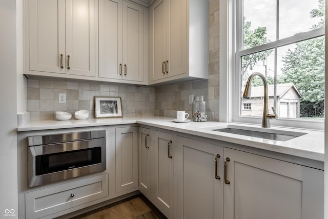 5682 Broadway St, Indianapolis, IN 46220 - kitchen with a sink, backsplash, stainless steel microwave, and oven