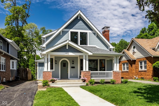 5682 Broadway St, Indianapolis, IN 46220 - view of front of house with a porch and a chimney