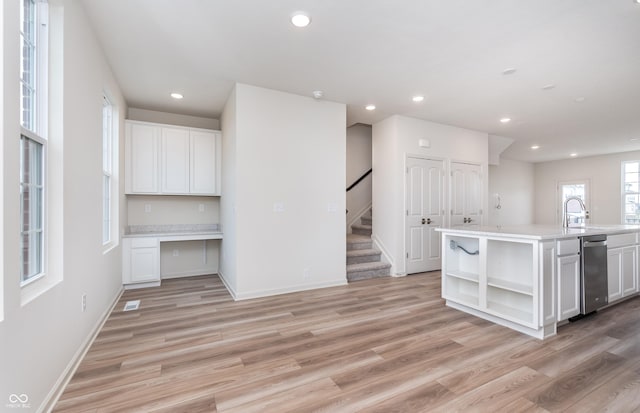 14515 Hanford Ln, Carmel, IN 46074 - kitchen featuring open shelves, light wood-type flooring, a sink, light countertops, and recessed lighting
