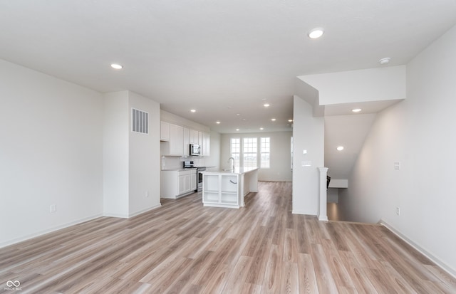 14515 Hanford Ln, Carmel, IN 46074 - unfurnished living room featuring light wood-style flooring, recessed lighting, baseboards, and a sink