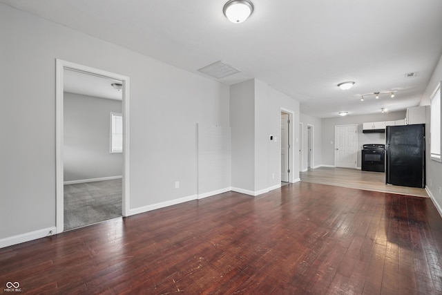 2030 Houston St, Indianapolis, IN 46218 - unfurnished living room featuring hardwood / wood-style flooring and baseboards