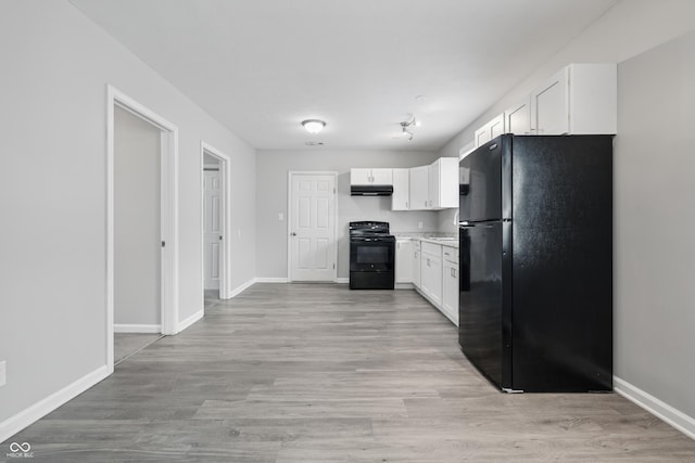 2030 Houston St, Indianapolis, IN 46218 - kitchen featuring black appliances, range hood, white cabinetry, and baseboards