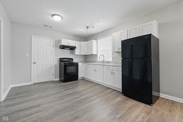2030 Houston St, Indianapolis, IN 46218 - kitchen featuring black appliances, under cabinet range hood, a sink, white cabinets, and light wood-style floors