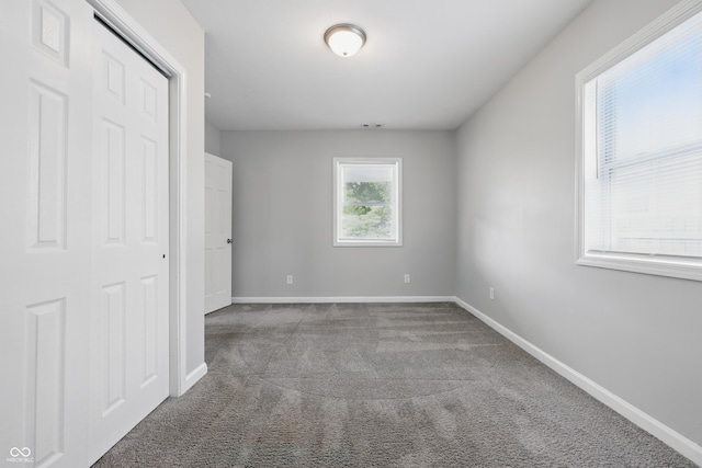 2030 Houston St, Indianapolis, IN 46218 - unfurnished bedroom with carpet flooring, baseboards, and a closet