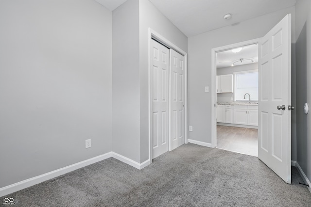 2030 Houston St, Indianapolis, IN 46218 - unfurnished bedroom with carpet, baseboards, and a closet