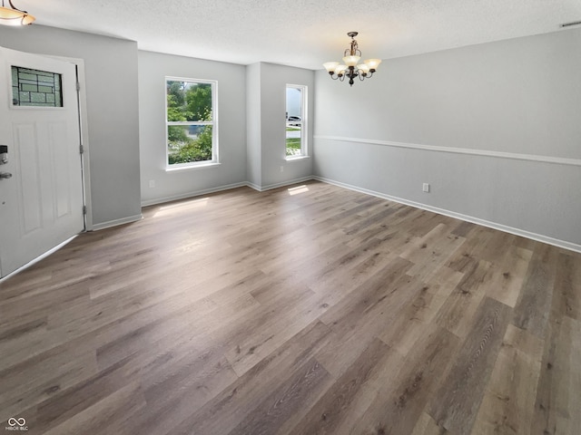 10366 Camby Xing, Fishers, IN 46038 - interior space with a chandelier, wood finished floors, baseboards, and a textured ceiling