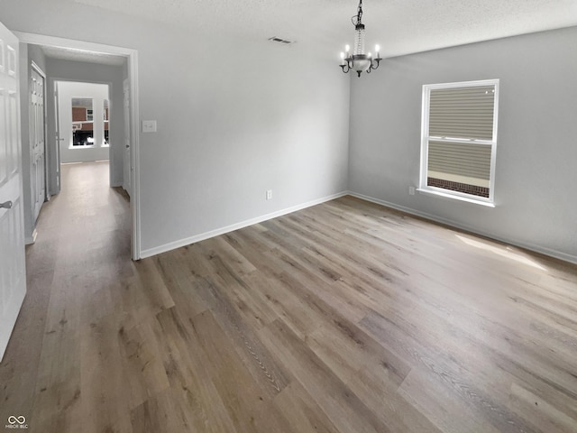 10366 Camby Xing, Fishers, IN 46038 - unfurnished dining area with a chandelier, wood finished floors, and baseboards