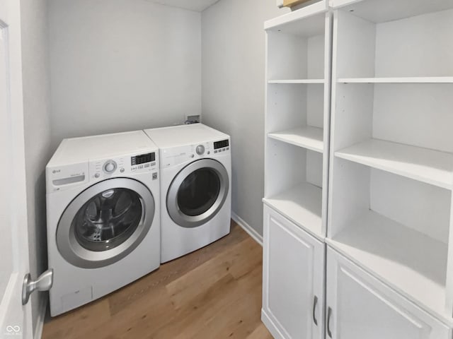 10366 Camby Xing, Fishers, IN 46038 - laundry area with washing machine and dryer and light wood-style flooring