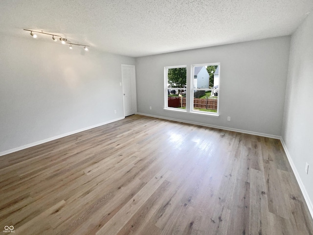 10366 Camby Xing, Fishers, IN 46038 - spare room featuring a textured ceiling, wood finished floors, and baseboards