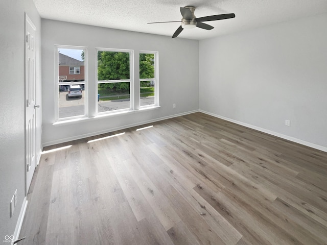 10366 Camby Xing, Fishers, IN 46038 - unfurnished room featuring a ceiling fan, a textured ceiling, wood finished floors, and baseboards