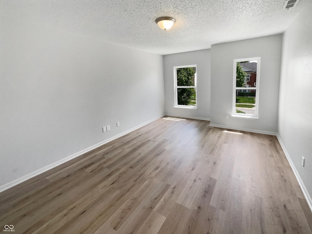 10366 Camby Xing, Fishers, IN 46038 - empty room featuring wood finished floors, a textured ceiling, and baseboards