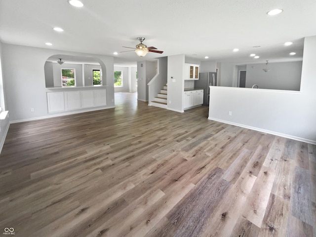 10366 Camby Xing, Fishers, IN 46038 - unfurnished living room featuring recessed lighting, baseboards, a ceiling fan, wood finished floors, and arched walkways