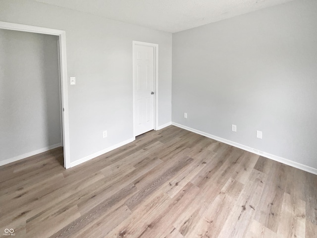 10366 Camby Xing, Fishers, IN 46038 - unfurnished bedroom with baseboards and wood finished floors