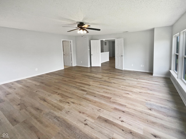10366 Camby Xing, Fishers, IN 46038 - spare room featuring wood finished floors, ceiling fan, a textured ceiling, and baseboards