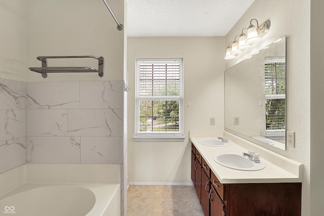 full bathroom featuring double vanity and a textured ceiling