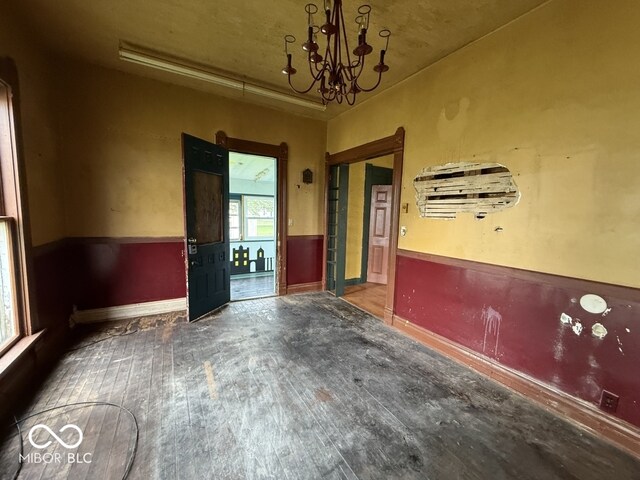 105 N Sheridan St, Ridgeville, IN 47380 - unfurnished dining area featuring hardwood / wood-style floors, a chandelier, and baseboards