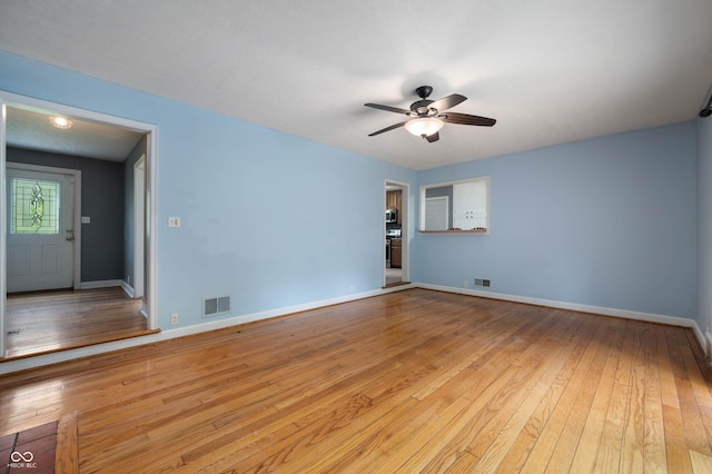 7910 N College Ave, Indianapolis, IN 46240 - empty room with light wood finished floors, ceiling fan, and baseboards