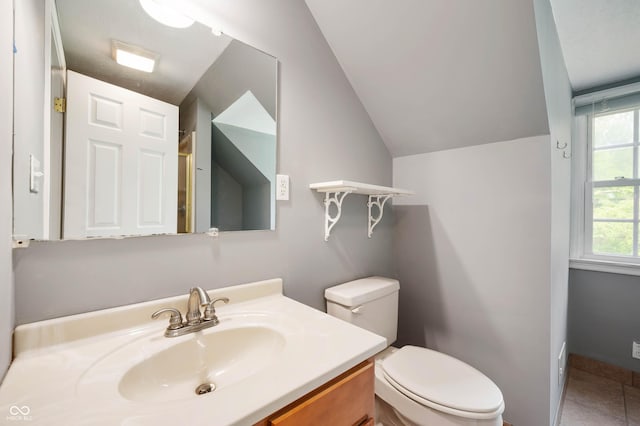 7910 N College Ave, Indianapolis, IN 46240 - bathroom featuring vaulted ceiling, vanity, and toilet