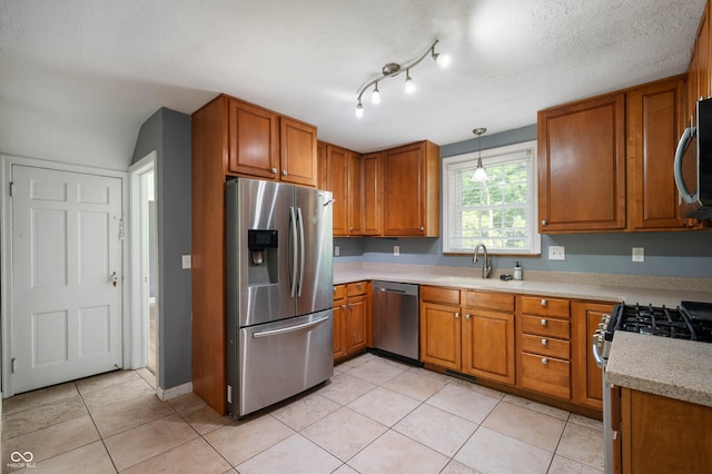 7910 N College Ave, Indianapolis, IN 46240 - kitchen featuring appliances with stainless steel finishes, a sink, brown cabinets, and light countertops