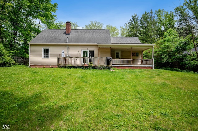 7910 N College Ave, Indianapolis, IN 46240 - rear view of property with a chimney, a yard, and a deck