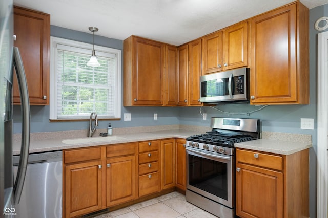7910 N College Ave, Indianapolis, IN 46240 - kitchen with appliances with stainless steel finishes, a sink, and brown cabinets
