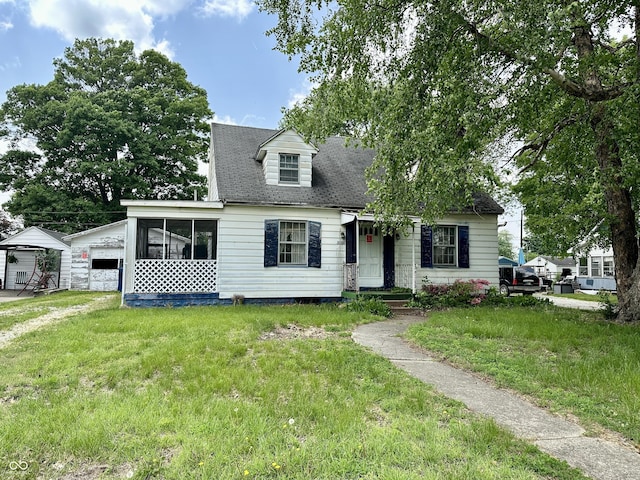 3060 N 16th St, Terre Haute, IN 47804 - cape cod-style house featuring a front lawn, a sunroom, and roof with shingles