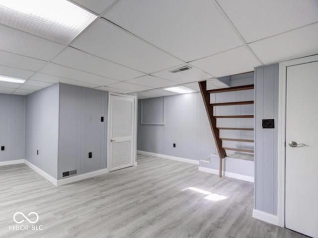 3342 Foltz St, Indianapolis, IN 46221 - finished below grade area featuring baseboards, light wood-type flooring, stairway, and a paneled ceiling