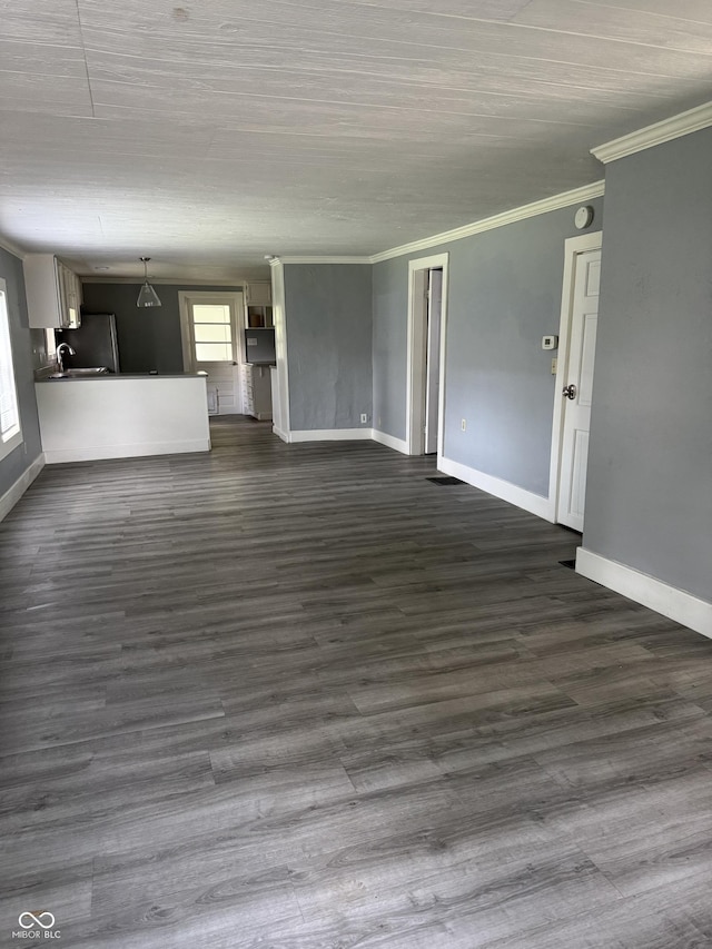 3342 Foltz St, Indianapolis, IN 46221 - unfurnished living room featuring crown molding, baseboards, and dark wood-type flooring