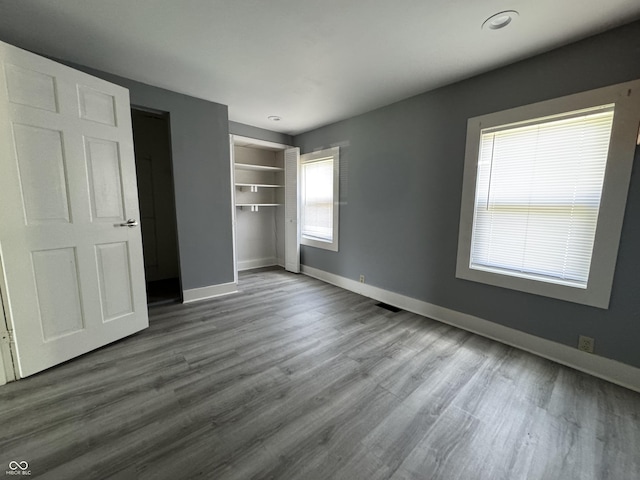 3342 Foltz St, Indianapolis, IN 46221 - unfurnished bedroom featuring baseboards, dark wood finished floors, and a closet