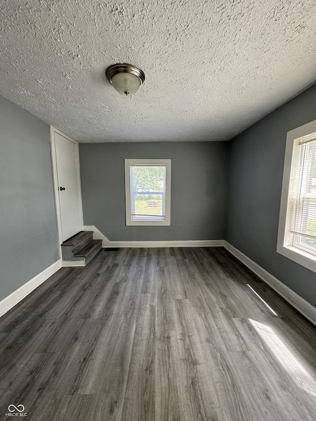 3342 Foltz St, Indianapolis, IN 46221 - spare room with dark wood-style floors, a textured ceiling, and baseboards