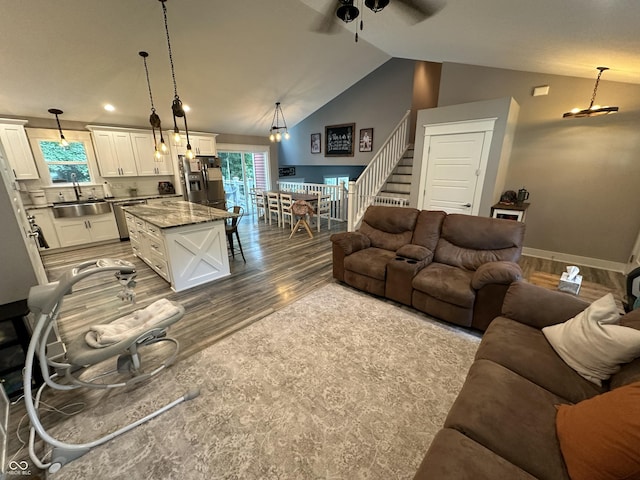 29 Victory, Coatesville, IN 46121 - living room with wood finished floors, stairs, lofted ceiling, a ceiling fan, and baseboards