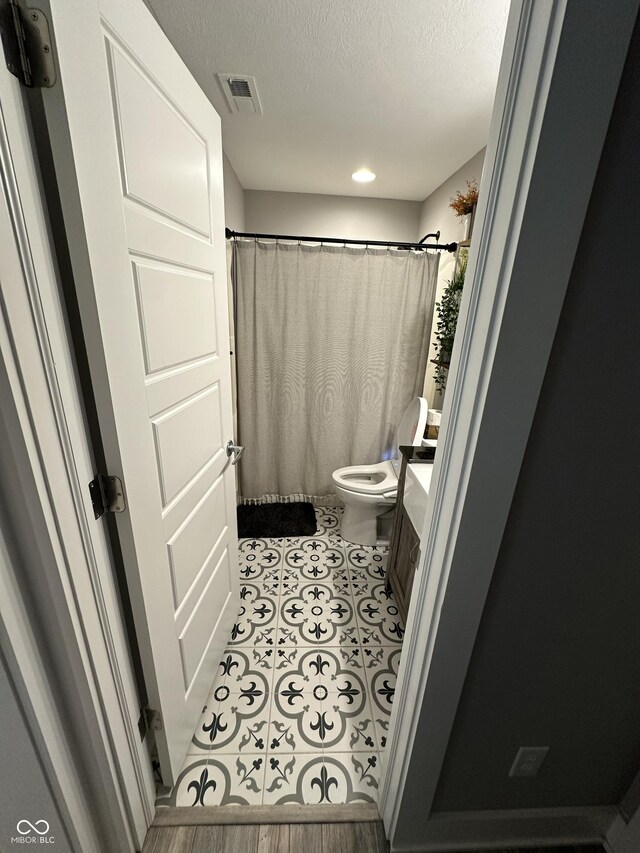 29 Victory, Coatesville, IN 46121 - full bath with toilet, a textured ceiling, vanity, a shower with shower curtain, and recessed lighting