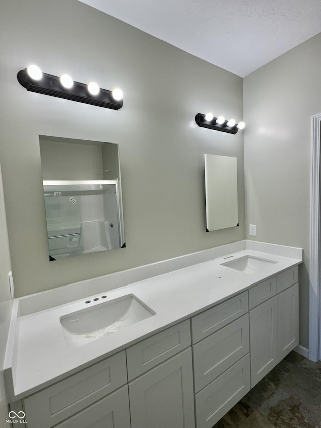 bathroom with an enclosed shower and double vanity