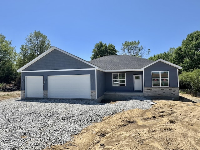 ranch-style home with stone siding and an attached garage